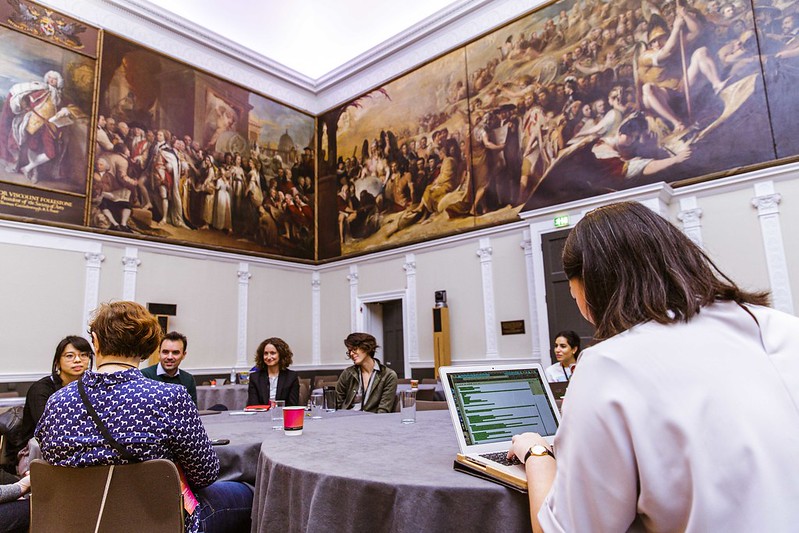 group of people talking around a table at a conference