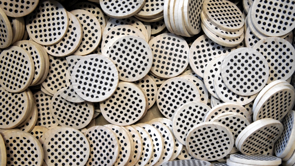 a pile of OpenNews wooden coins